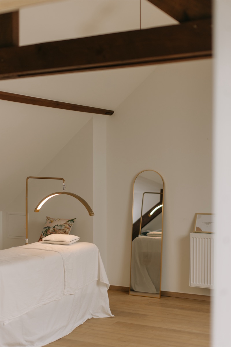 The Maya salon interior in Bruges, with warm wood and natural light