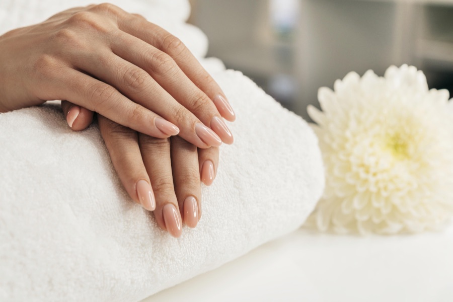 A manicure being applied during a nail care treatment at Maya